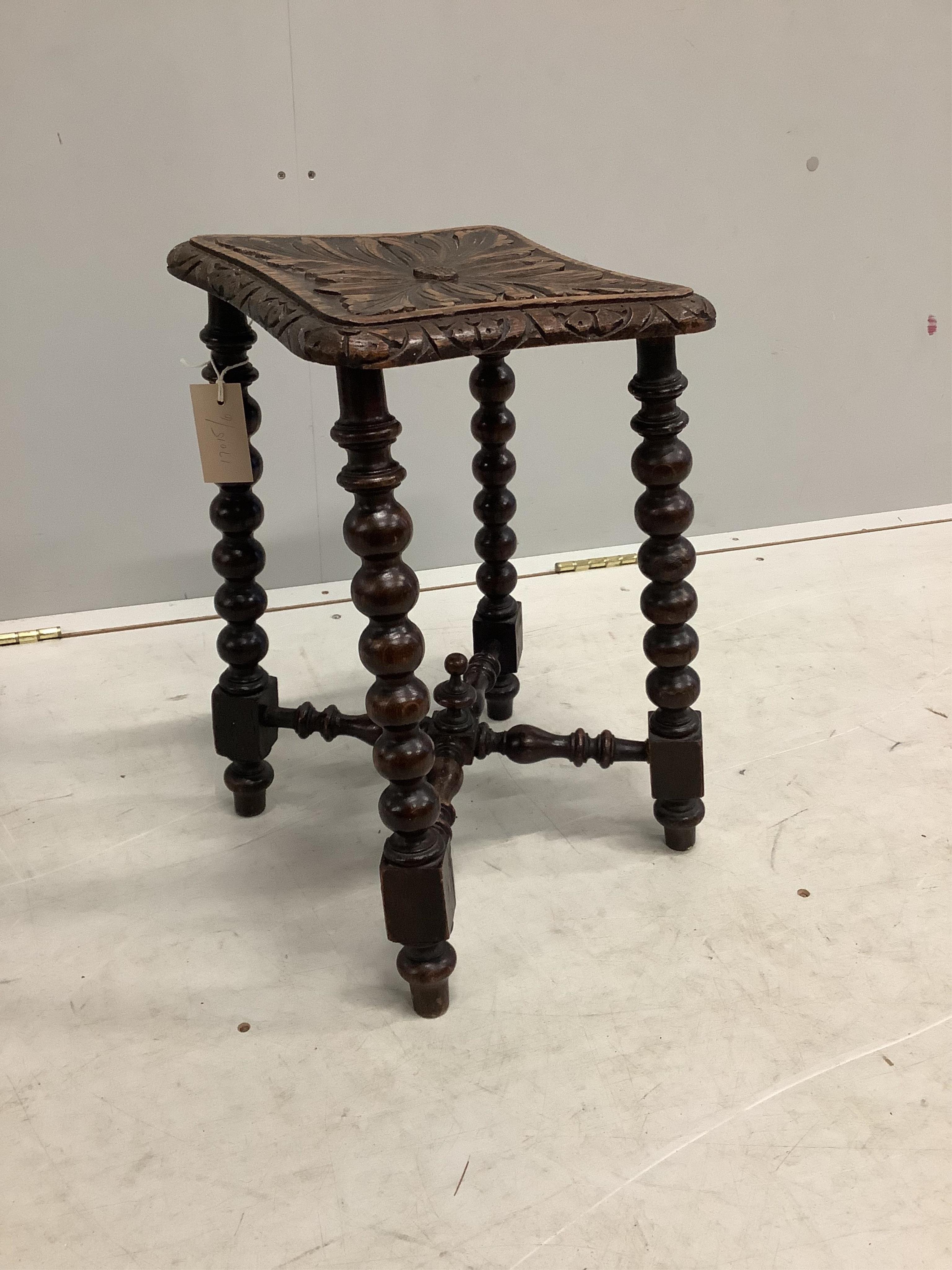 A Victorian carved oak bobbin turned stool, bears Bruce & Co. trade label, height 46cm. Condition - fair